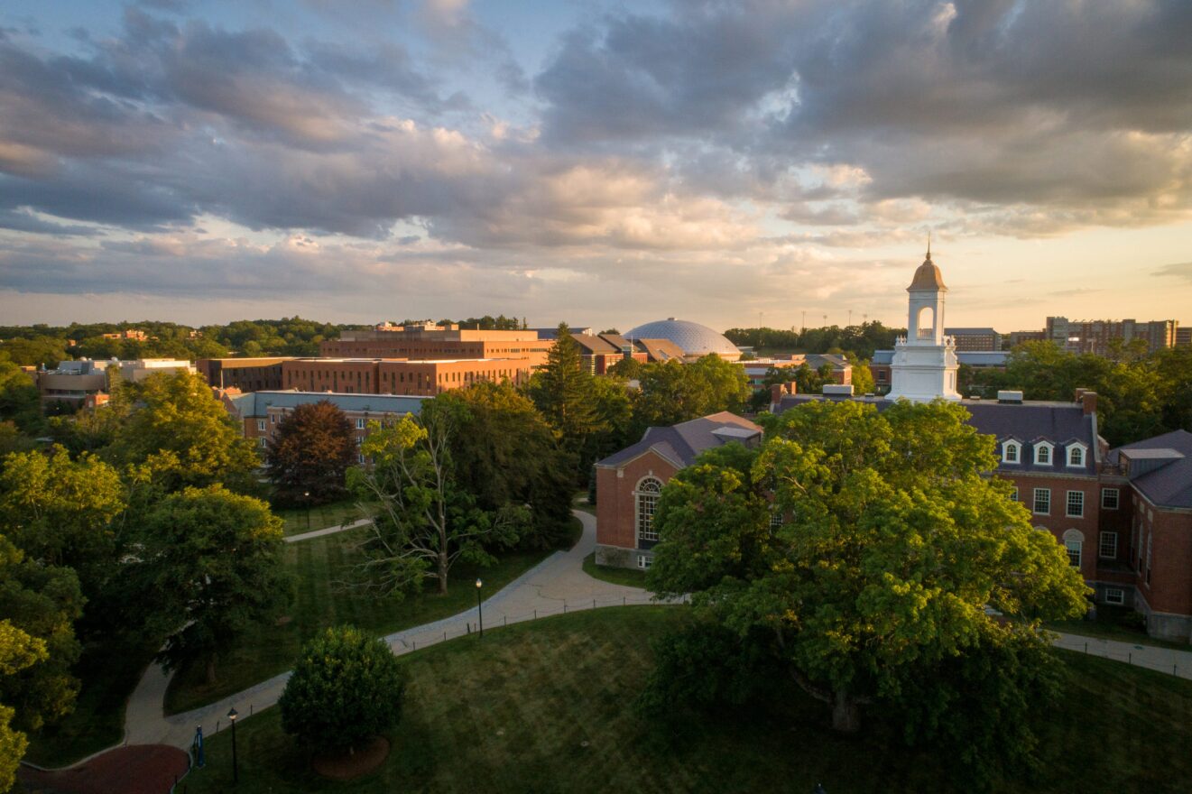 The spire of the Wilbur Cross building at UConn rises above the campus in this July 2019 photograph.